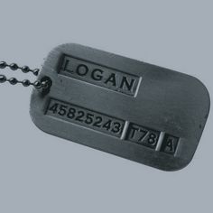 two metal tags with the words logan on them hanging from a black ball chain