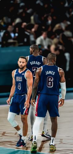 three basketball players are standing on the court