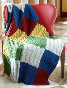 a red chair with a blanket on top of it