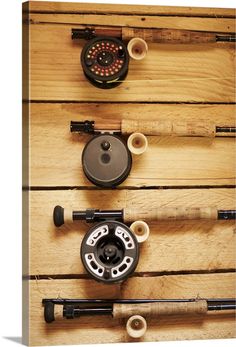 fishing rods and reels mounted on wooden planks