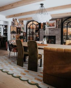 a living room filled with lots of furniture and pictures on the wall behind the couch