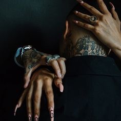 a person with tattoos on their arms and hands