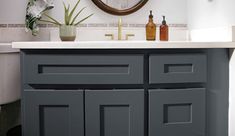 a bathroom with a sink, mirror and toiletries on the counter top in front of it