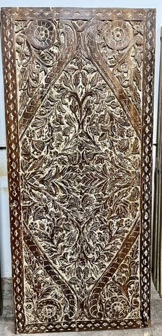 an intricately carved wooden panel on display