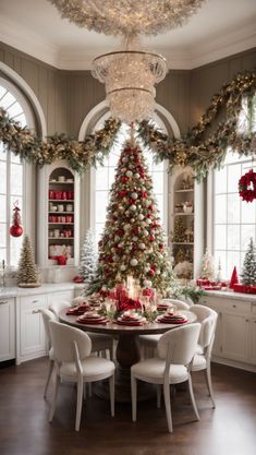 a christmas tree in the middle of a dining room table with red and white decorations