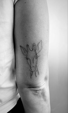 a giraffe tattoo on the left arm