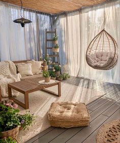 a living room filled with lots of furniture and hanging chairs next to a wooden floor