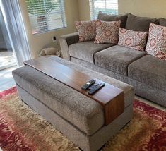 a living room filled with furniture and a red rug