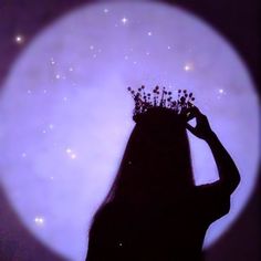 the silhouette of a woman with flowers in her hair is shown against a purple background