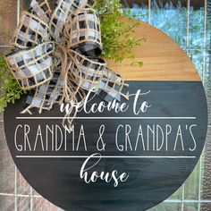 a welcome sign with a bow on it that says, welcome to grandma and grandpa's house