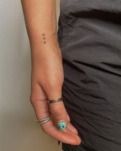 a woman's hand with a small tattoo on it