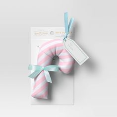 a pink and white striped donut with a blue ribbon