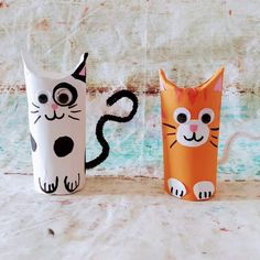 two paper cups with cats painted on them