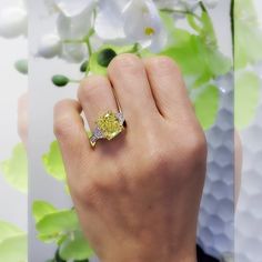 This stunning Canary Fancy Yellow Elongated Radiant Cut Engagement Ring features a huge 5.50 Ct. fancy yellow radiant cut diamond with VVS1 clarity. Half moon cut diamonds and Pave round cut diamonds (1.20 ct. t.w.) frame the canary diamond completing the 3-stone look. Metal : 14K Gold, 18K Gold or Platinum Setting Type : Pave Total Carat : 6.70 Carats Type : Natural Diamond Shape : Radiant Cut Carat Weight : 5.50 Ct. (GIA Certified) GIA Certificate : Included Measurement : Contact us to obtain Engagement Rings Canary Diamond, Elongated Radiant Cut Engagement Rings, Yellow Canary Diamond Ring, Luxury Yellow Jewelry With Single Cut Diamonds, Canary Yellow Diamond Bracelet, Canary Diamond Engagement Ring, Fancy Intense Yellow Diamond Ring, Engagement Rings On Finger, Radiant Cut Diamond Engagement Rings