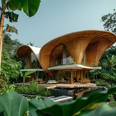 an unusual house in the middle of some tropical trees and greenery is featured on this photo