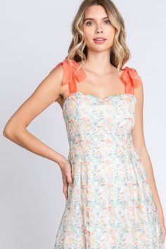 Lovelo by Gee Gee Beautiful classy embroidered sheer fabric midi dress with sweetheart neckline and self tie ribbon shoulder straps. Lined. Low back, zipper in the back. Absolutely beautiful! Color: Off White/Tangerine/Green Sizes: S-M-L Bust 32-34-36 85% Polyester, 15% Nylon, Lining 100% Rayon D1/MD50555 Spring Dresses With Tie Straps And Fitted Bodice, Summer Dress With Sweetheart Neckline And Bow Tie Back, Tie Strap Midi Dress For Garden Party, Feminine Dress With Bow Straps And Sweetheart Neckline, Feminine Dress With Sweetheart Neckline And Bow Straps, Fitted Bodice Midi Dress With Tie Straps For Brunch, Lace Dress With Tie Back And Sweetheart Neckline, Spring Mini Dress With Sweetheart Neckline And Bow Straps, Sleeveless Dress With Bow Tie Back For Garden Party