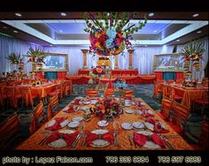 an image of a dining room setting with orange and red decorations on the table cloths