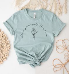 "Allow Yourself To Grow T-shirt, Inspiring Shirt, Wildflower Gift, Bestfriend Shirts, Plant Tee, Botanical T-shirts, Plant Lover Tee, Inspirational Shirts, Gift For Wife, Birthday Gift, Present For Woman, Wildflower Shirt, Gift For Girl, Bestfriend Tee, Botanical Tee, Plant Lover T Shirt, Inspiring Women, Allow Yourself, To Grow Shirt, Graphic Shirt, Take Care Yourself This updated unisex essential fits like a well-loved favorite. Super soft cotton and excellent quality print makes one to fall in love with it over and over again. ------------- Fabrication ------------- 100% Combed ring spun cotton Made by specially treating the cotton fibers before spinning them into yarn. The result is stronger and smoother fabric. ------------- Unisex T-shirt Size Chart ------------- XS - - 27\" Length a Inspirational Letter Print T-shirt For Spring, Spring Crew Neck T-shirt With Quote Print, Inspirational Crew Neck Summer Top, Inspirational Short Sleeve Summer T-shirt, Spring Cotton Tops With Quote Print, Cotton Tops With Graphic Print, Cotton Tops With Quote Print For Spring, Spring Graphic Tee With Quote Print, Inspirational Crew Neck Tops For Spring