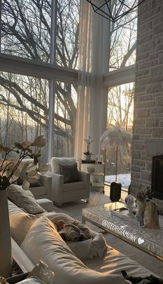 a living room filled with furniture and large windows