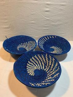 three blue bowls with gold designs on them