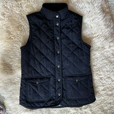 Nwt This Black Size Large Vest Is So Cozy And Is So Versatile. The Front Of The Quilted Vest Has Two Snap Pockets, Full Zipper, And An Additional Seven Snaps In Gunmetal Silver. The Back Bottom Of This Vest Has Two Buttons That Can Be Unbuttoned For More Movement And Room, Or Buttoned For A Snugger Fit. Great For Fall, Winter And Spring. “ From A Smoke And Pet Free Home” Black Vest Outerwear For Cold Weather, Fitted Black Vest For Cold Weather, Black Winter Vest Outerwear, Black Fitted Vest For Cold Weather, Black Cold Weather Vest Outerwear, Campus Fashion, London Women, Campus Style, Quilted Vest