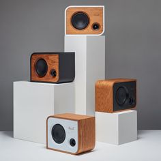 the speakers are stacked on top of each other in front of a gray background,