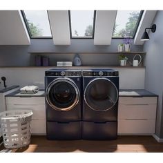 a washer and dryer in a small room with skylights on the windows