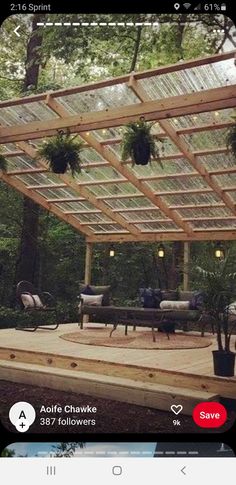 an outdoor living area with seating and plants on the deck, surrounded by greenery