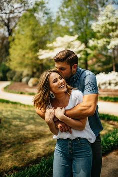 a man and woman embracing each other in the park