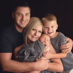 a man, woman and child are posing for a family photo with their arms around each other