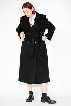 Indulge in timeless elegance with our Double-Sided Wool Black Wrap Coat. This heavyweight classic exudes sophistication and comes complete with a belt for versatile styling. The double-breasted design adds an extra layer of refinement, while the two pockets provide both style and convenience. What sets this coat apart is its full lining, ensuring comfort and warmth in every wear. Wrap yourself in luxurious fashion that effortlessly combines style and practicality. Elevate your winter wardrobe with this standout piece that promises both cozy comfort and chic allure. Composition: 100% Wool Heavyweight fabric Designed for a relaxed fit, fits true to size Made in New York SNOWXUEGAO.COM Classic Fitted Outerwear With Belt Detail, Tailored Formal Outerwear With Belt Detail, Elegant Notch Lapel Outerwear With Belt, Elegant Outerwear With Notch Lapel And Self Belt, Elegant Outerwear With Self Belt And Notch Lapel, Classic Belted Formal Outerwear, Elegant Business Outerwear With Belted Cuffs, Classic Formal Outerwear With Belt Detail, Luxury Belted Outerwear For Formal Occasions