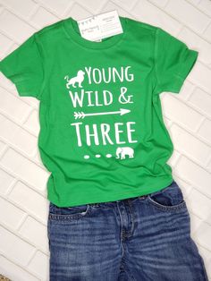 "When it comes to celebrating a 3rd birthday, a plain ol' shirt will never do! If your soon-to-be three year old is totally loveable but slightly wild? Does he LOOOOVE jungle animals? Then this \"Young Wild & THREE\" shirt will be a perfect match for your lil guy! ------------------------------------------------------------- 3rd Birthday shirt: All shirts are short-sleeve and fit true-to-size (boutique brand) - Long-sleeve shirts are available by special order. Please contact us before order Playful Green T-shirt For Birthday, Green Graphic Print T-shirt For First Birthday, Green T-shirt With Letter Print For First Birthday, Green Fun Birthday T-shirt, Green Casual Top For First Birthday, Green Short Sleeve Top For First Birthday, First Birthday Green Top With Letter Print, Birthday Letter Print Green Shirt, Green Short Sleeve Shirt For Birthday