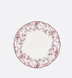 a red and white plate with flowers on it