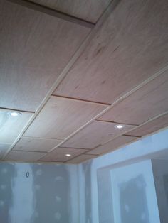 an unfinished ceiling with light bulbs and wood paneling