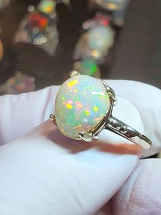 Beautiful rainbow colored teardrop opal with a turquoise background, 11x13mm 5.58cts mounted on a small but solid scroll design Italian silver ring, low profile and of simple design. Comes in sizes 7,8. White Oval Ethiopian Opal Rings, White Ethiopian Opal Ring For Anniversary, White Ethiopian Opal Oval Rings, White Teardrop Opal Ring For Anniversary, White Cabochon Opal Ring, White Oval Cabochon Opal Ring, Iridescent Opal Promise Ring, White Teardrop Opal Ring For Gift, White Opal Oval Cabochon Ring