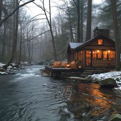 a small cabin sits next to a stream in the woods