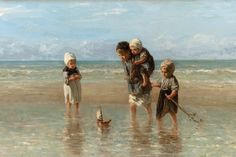 three children playing on the beach with a boat in the water and one child holding a stick