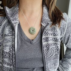 "Gorgeous Burmese jade donut pendant. Comes in shades of white and green. The pretty donut shape jade promotes good fortune and luck to the wearer. Green Jade is associated with the heart and root Chakras. Size range from 27mm to 37 mm Approx weight 10 g Option to purchase an 18\" solid sterling silver necklace." Green Round Disc Necklace For Gift, Jade Necklace With Large Pendant For Gifts, Green Circle Jade Necklace, Jade Gemstone Round Pendant Necklace, Green Jade Circle Necklace, Circular Green Jade Necklace, Spiritual Jade Round Pendant Necklace, Hand-strung Round Jade Necklace, Jade Donut Pendant