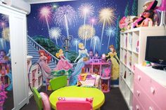 this is a child's bedroom decorated in pink, green and yellow with princesses on the wall