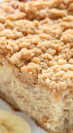 a close up of a piece of cake on a plate with a banana next to it