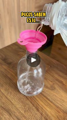 a bottle filled with water sitting on top of a wooden table