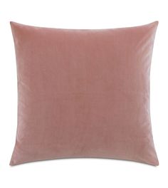 a pink velvet pillow on a white background