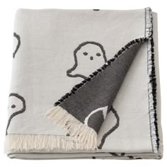 a gray and white blanket with ghost on it