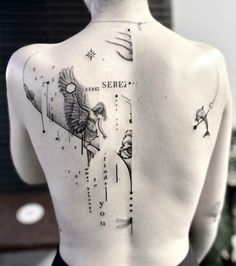 the back of a person's body with tattoos on it