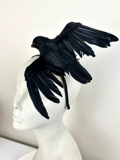 "The Birds- black Fascinator- Feather Headband- Halloween - Crow- Derby-  Ravens - Goth- Steampunk. Hello, This fascinator is perfect to add wimsey and is just so fun you'll be the life of the party.  A great conversation piece.       This black feather fascinator has a black bird with wings.  It's  not a real bird, its plastic covered with feathers and very light. It is about  5\" and wings are It is placed on a 1/8\" black satin headband covered stainless steel headband that is adjustable to f Crow Headpiece, Fitted Black Headpiece With Feathers, Derby Headband, Sea Creature Costume, Adjustable Black Feather Headpiece, Luxury Black Feathered Headpieces, Adjustable Black Feathered Headpiece, Crow Costume, Floral Fascinators