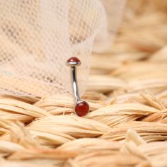 a close up of a ring with a red stone on it sitting in a basket