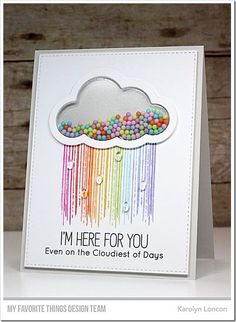 a card with a cloud and rainbows on it