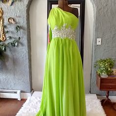 Beautiful Embellished Chartreuse Evening Gown Will Have All Eyes On You Throughout The Evening. Never Worn With Tags Still Attached. This Is A Yishaer Wedding Dress. But This Dress Can Be Worn For Any Special Event You Might Want To Look Fantastic For. One Shouldered Dress With A Full Coverage Bodice, One Crossover Back Strap And A Lovely Scarf That Drapes From The Right Should Down The Back. Hidden Zipper. This Dress Is A Beauty And In Perfect Condition. Green Floor-length Bridesmaid Dress, Green Evening Dress With Sweep Train For Homecoming, Green Homecoming Evening Dress With Sweep Train, Green Embellished Ball Gown Evening Dress, Green Floor-length Mother Of The Bride Dress, Green Gown With Sweep Train For Homecoming, Green Homecoming Gown With Sweep Train, Green Bridesmaid Gown With Sweep Train, Bridesmaid Green Gown With Sweep Train