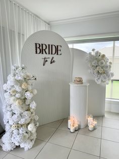 a white room decorated with flowers and candles