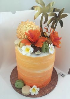 there is a cake with flowers on the top and an orange frosting around it